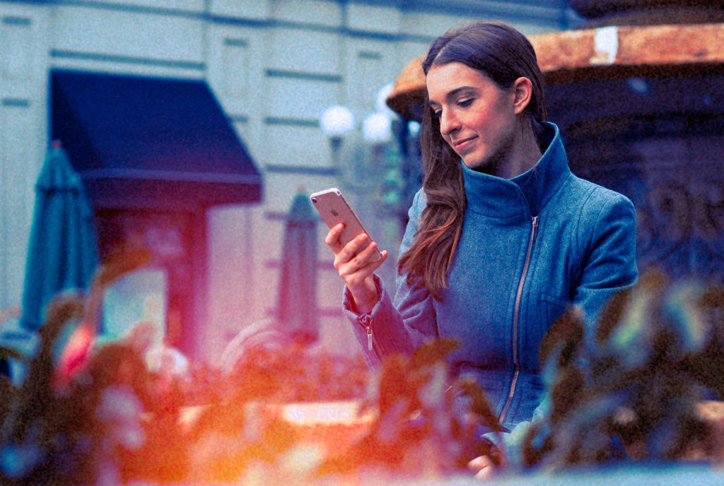 young woman getting free insurance quote on the mobile phone
